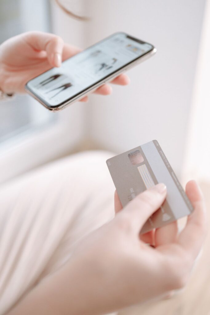 A person holding a credit card, illustrating payment card fraud