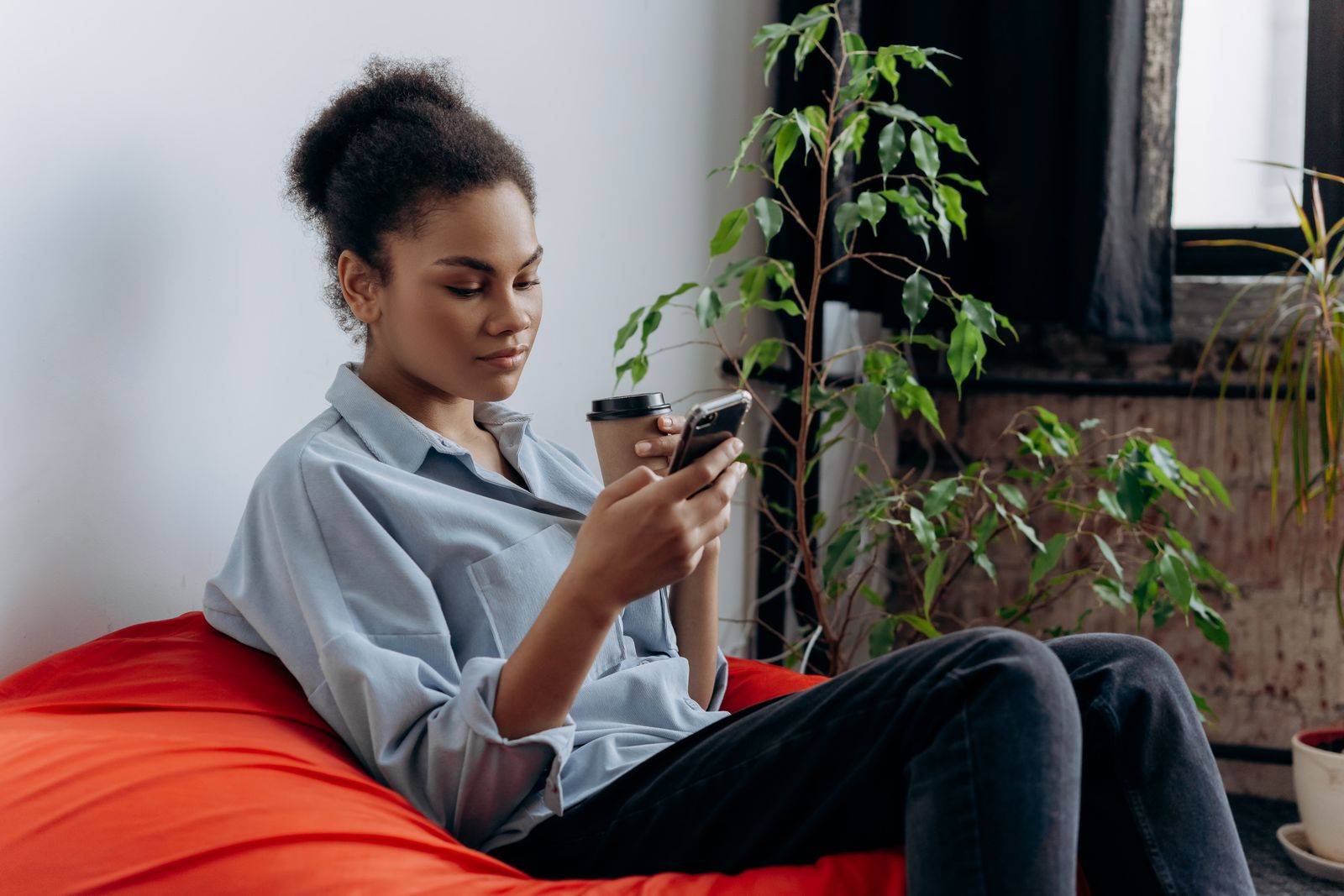 A woman attentively checking a message on her phone