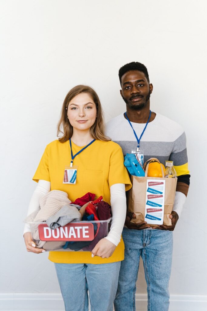 Two people handing over a donation box