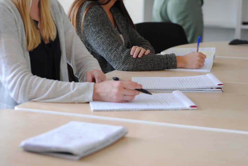 A woman writing notes while learning