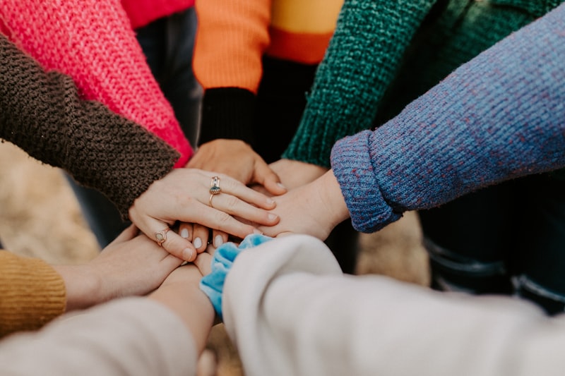 A group of hands stacked together in unity