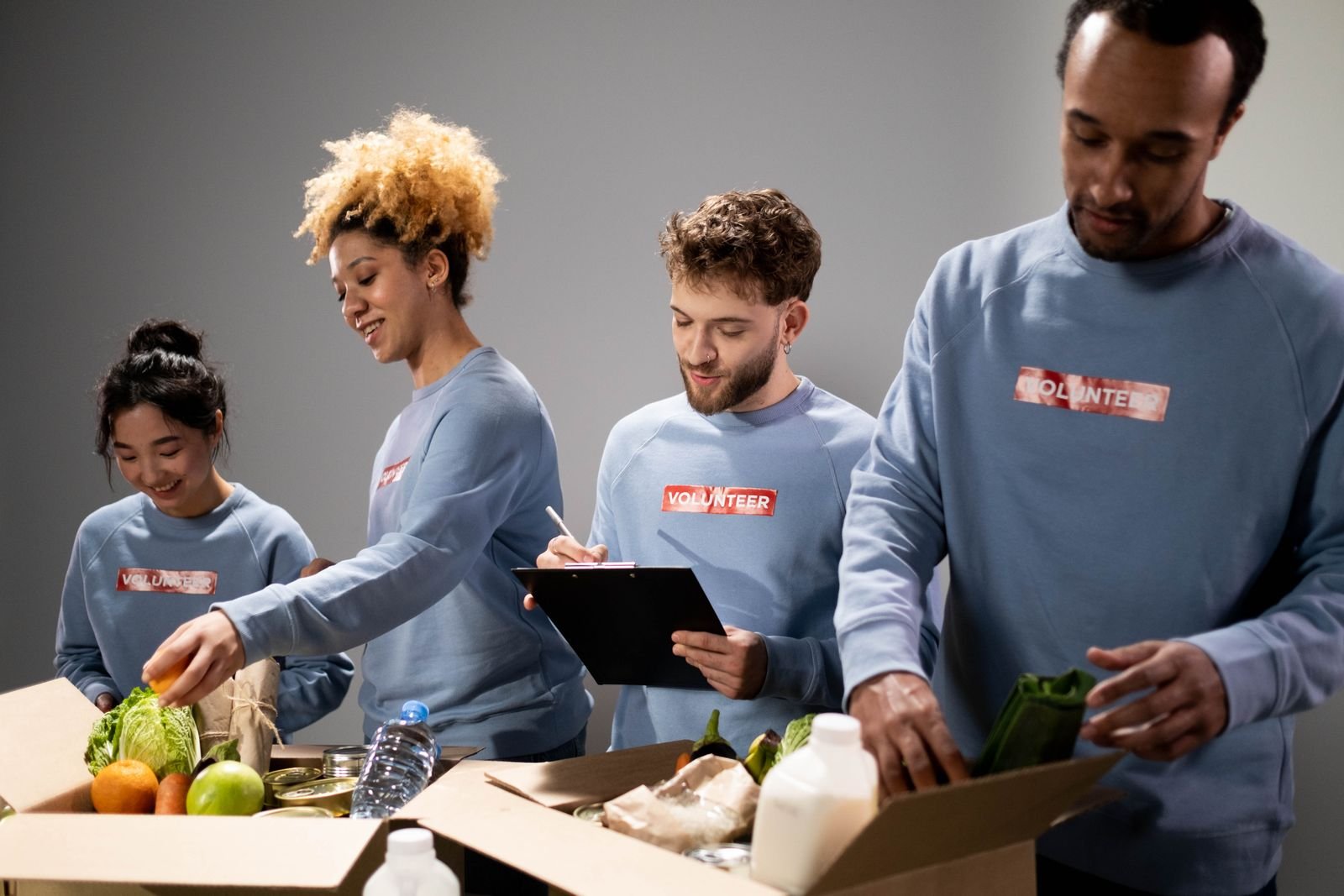 A diverse group of volunteers packing donations together
