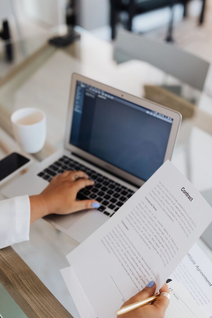 A person reviewing a document at a laptop, illustrating protecting your personal information