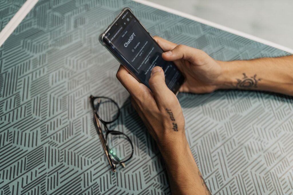 A hand holding a phone with an AI chatbot app open