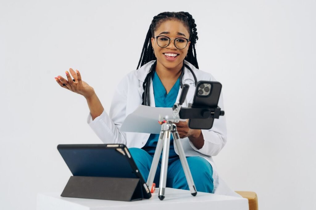 A doctor using a tablet and phone for an online consultation