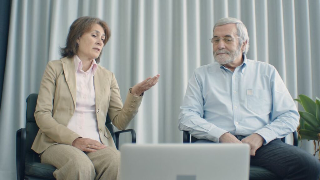 An older couple having a video call on a laptop