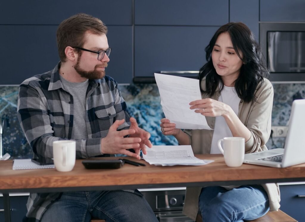 A couple reviewing financial paperwork together at home