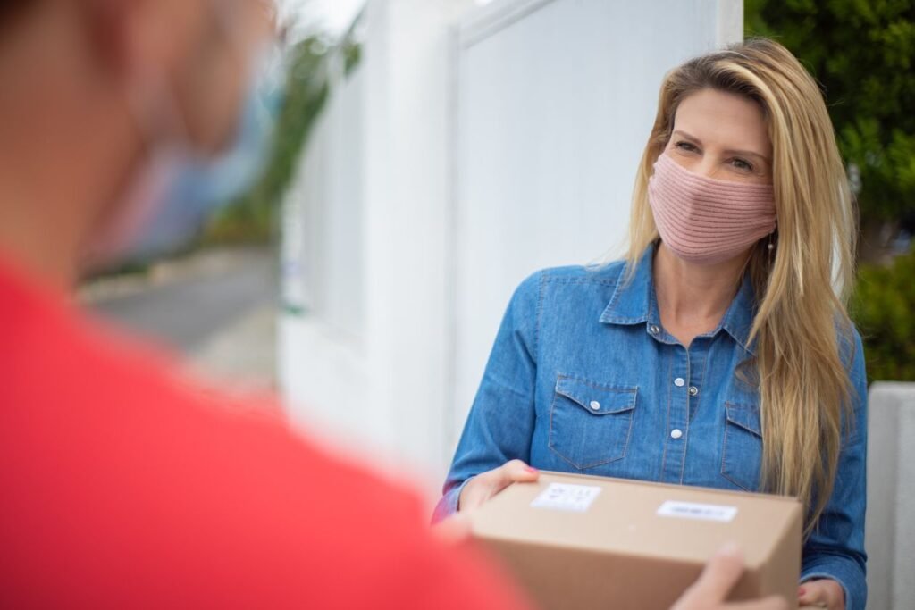 A woman receiving a package delivery at her door